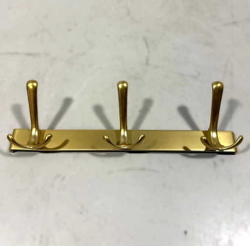 Goudkleurige aluminium wandkapstokken jaren 1960
