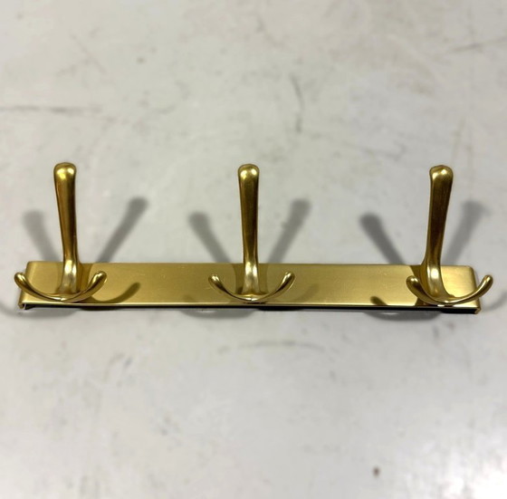 Image 1 of Goudkleurige aluminium wandkapstokken jaren 1960