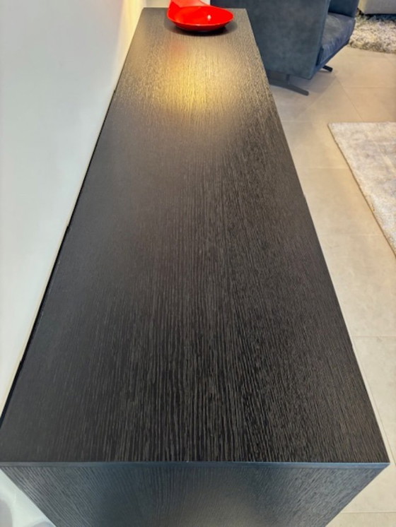 Image 1 of KENDO IS A SIDEBOARD WITH UNUSUAL GEOMETRIC DOORS: EACH ONE HAS A 30° CUT THAT DIVIDES IT INTO TWO PARTS THAT ARE NOT PERFECTLY 