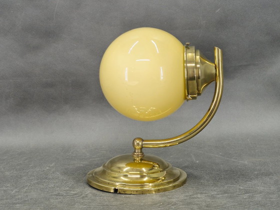 Image 1 of Tsjechische art-deco wandlamp van messing en champagneglas uit de jaren 1930.