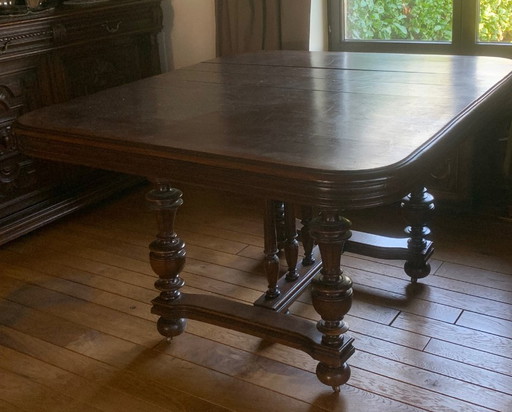 Antique, oak extendable table and 8 matching chairs on casters