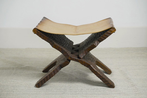 Image 1 of Brutalist Folding Stool Leather Sling Seat Hand Carved Wood X Frame 1950s Rustic Mid Century Ottoman