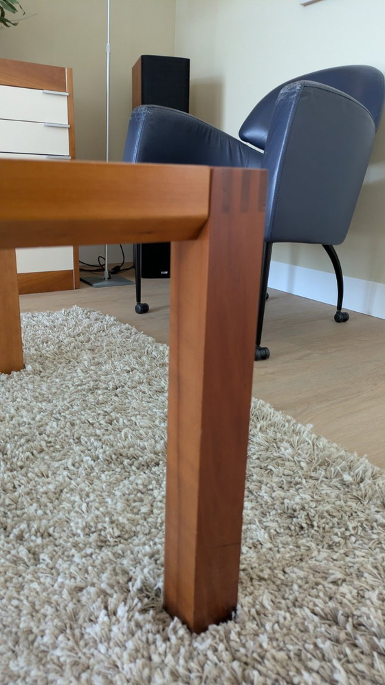 Image 1 of cherry wood red coffee table with sleek glass top from 1996