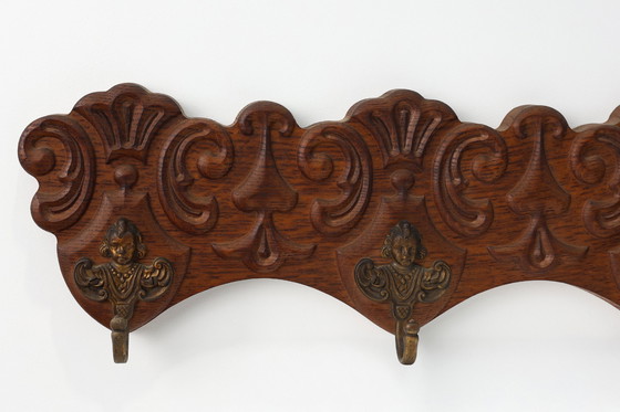 Image 1 of Antique Carved oak Wall mount coat rack with 3 brass angel hooks, France 1900s