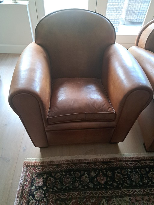 2 cognac colored leather armchairs by Artistic