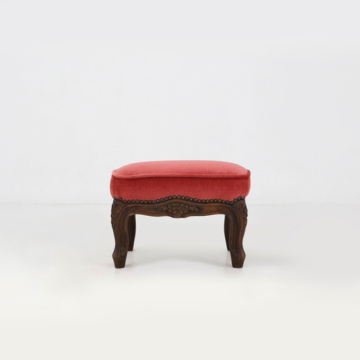 Baroque style foot stool in carved wood with coral velvet upholstery