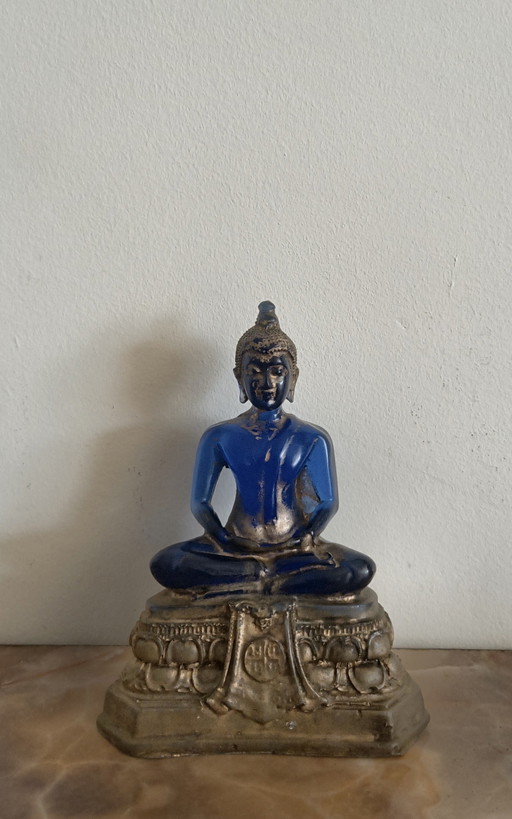Old Buddha made of blue glass and stone material.