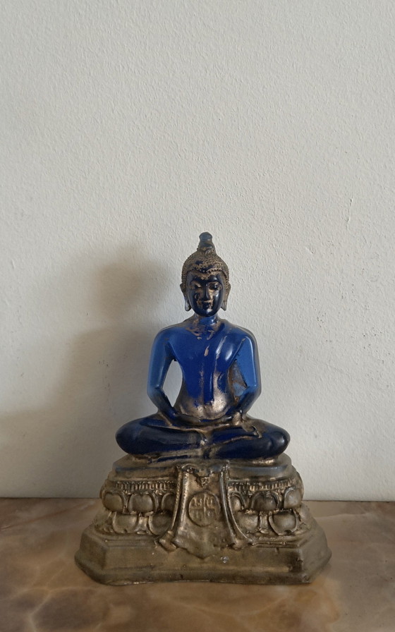 Image 1 of Old Buddha made of blue glass and stone material.