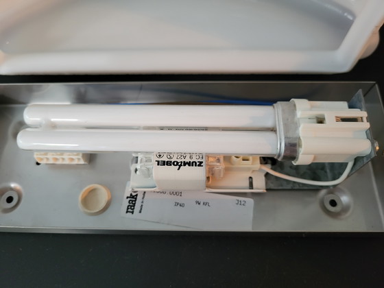 Image 1 of 3 RAAK (bathroom) wall lamps with opaline glass shade and stainless steel frame.