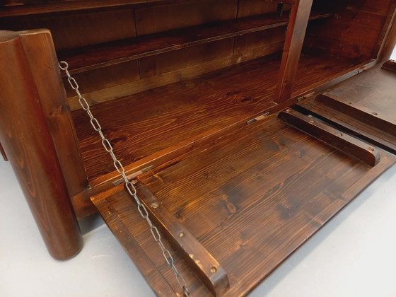 Image 1 of Een laag, brutalistisch dressoir van Georges Robert, gemaakt van donker grenenhout, uit de jaren 50/60.