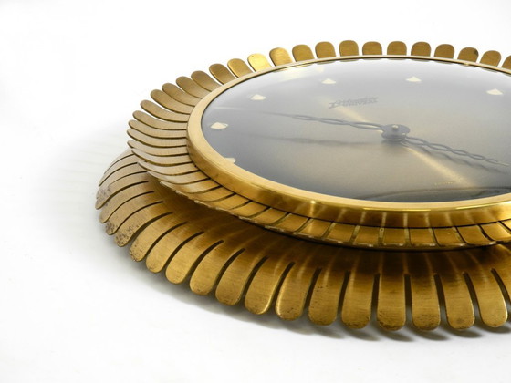 Image 1 of Beautiful original Mid Century Sunburst Atlanta Universe wall clock made of heavy brass with a mechanical seven-day movement