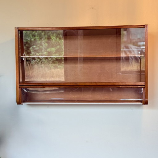 Hanging display case with flap at the bottom
