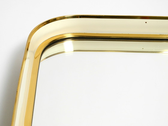 Image 1 of Prachtige originele Mid Century Moderne "Zier-Form" wandspiegel met zware messing lijst door "Münchener Zierspiegel".