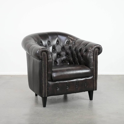 Luxurious dark cowhide Chesterfield club armchair in English style