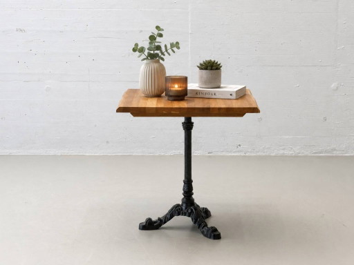 Bistro table made of acacia wood with a cast iron base in country style
