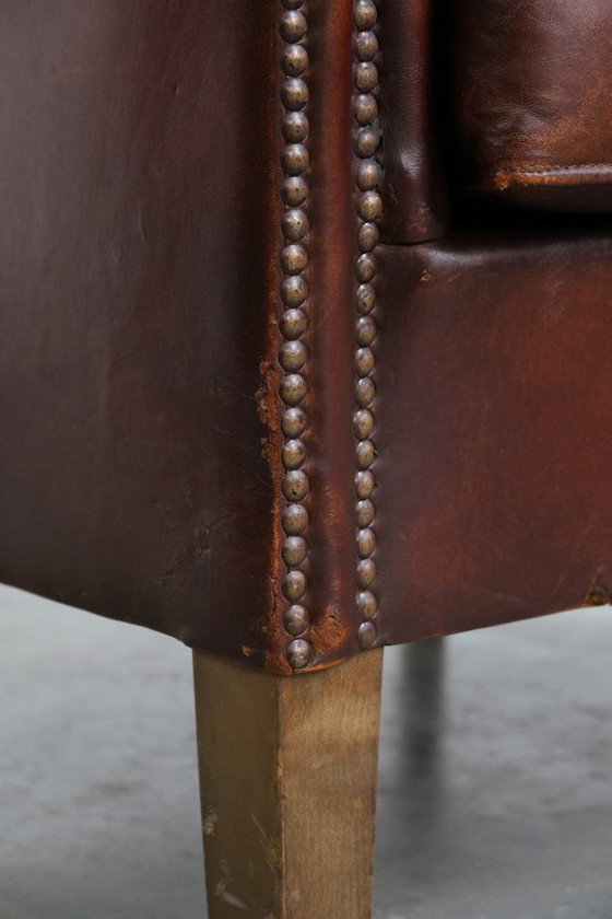 Image 1 of Vintage clubfauteuil gemaakt van schapenleer met siernagels
