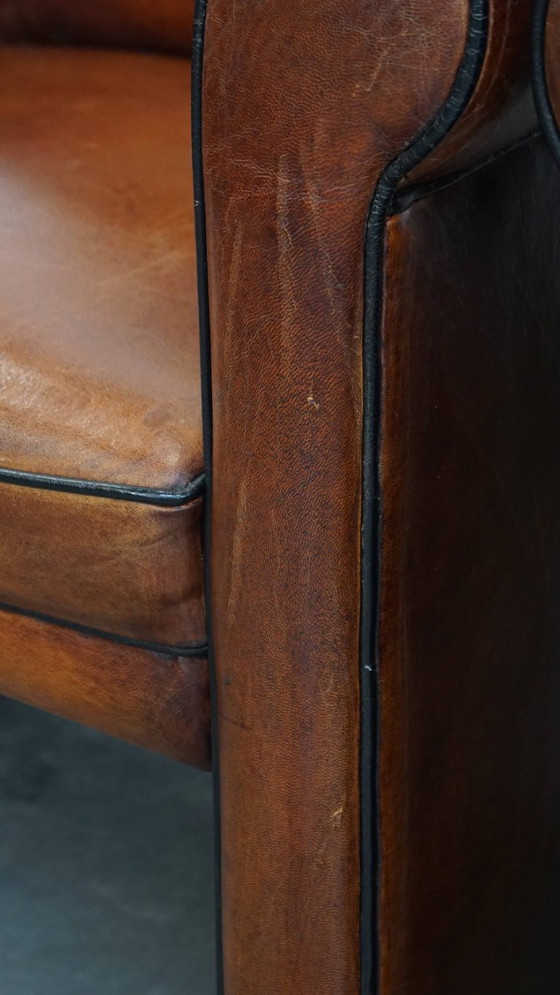 Image 1 of 4 x Vintage schapenleren eetkamerstoel met zwarte biezen op wieltjes