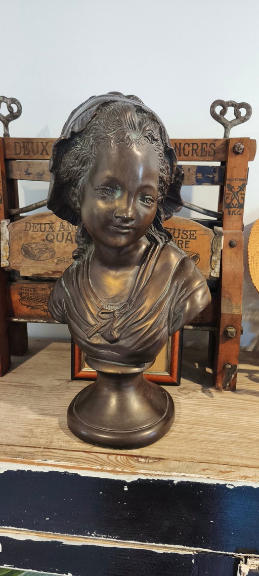 Old statue, Bust of a French girl, a peasant woman in a bonnet.