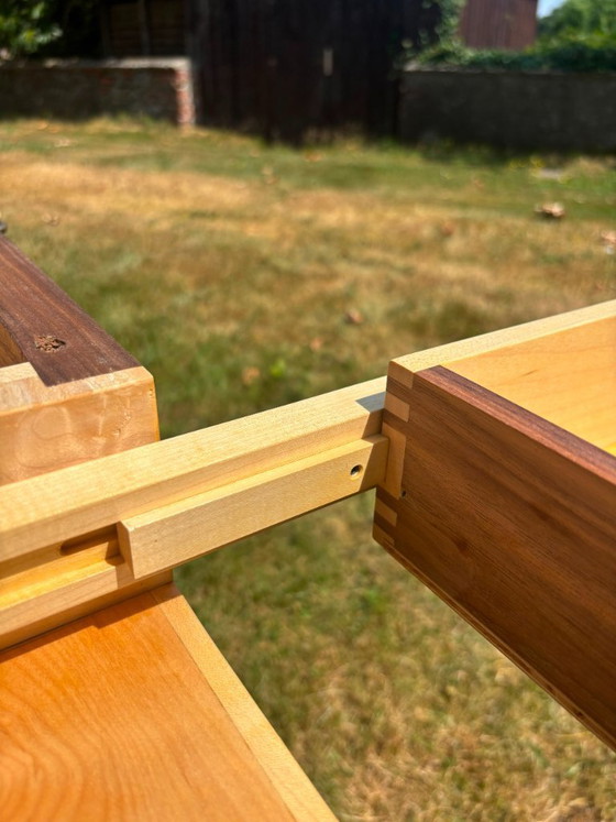 Image 1 of Dining table in American walnut and maple. Handcrafted solid wood extensions and drawers. Live edge for visual depth. Epoxy resi