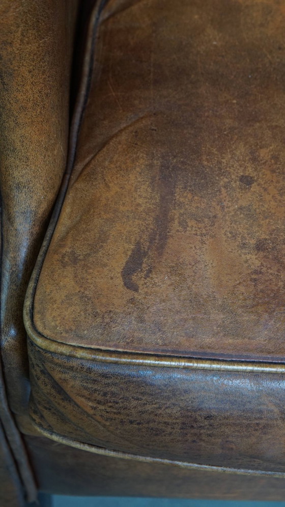 Image 1 of Karaktervolle vintage schapenleren oorfauteuil met een mooi patina