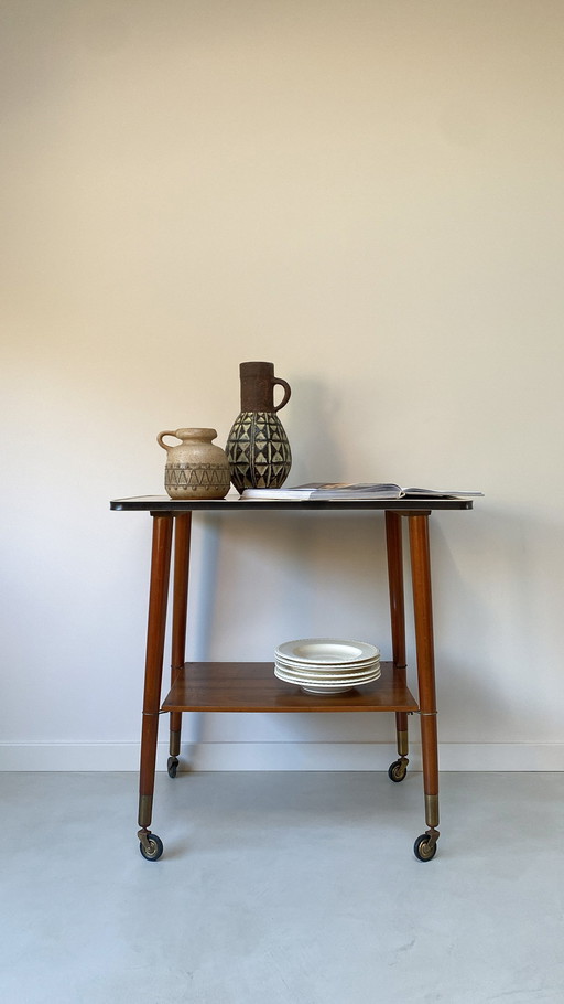 Vintage wooden trolley on wheels with formica top