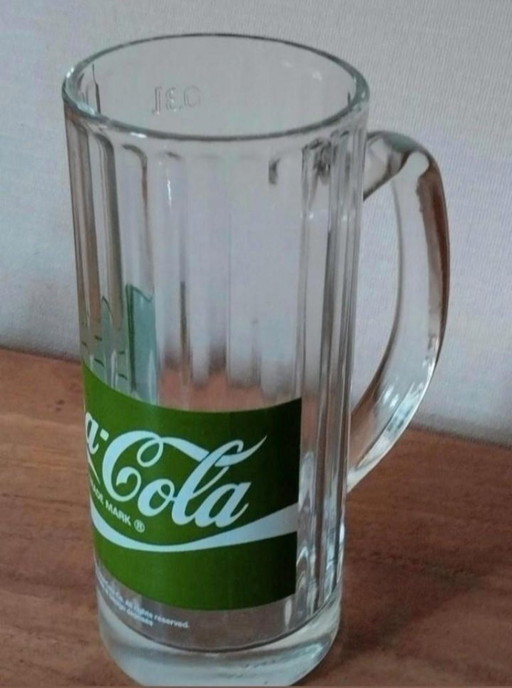 Three vintage Coca Cola glasses.