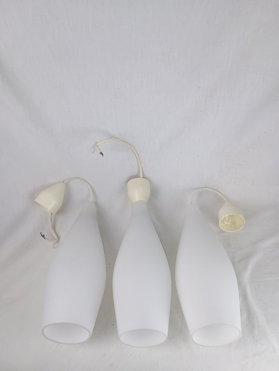 Image 1 of Elegant and timeless, this set of three original Holmegaard glass pendant lamps