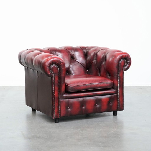Red English cowhide Chesterfield club armchair finished with decorative studs