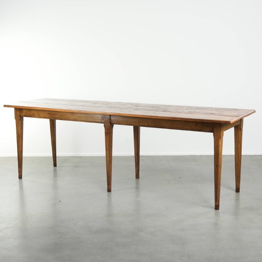 Large, relatively narrow antique French farmhouse dining table made of pine from the early 19th century with a beautiful patina.