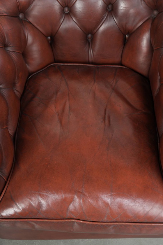 Image 1 of Beautiful red/brown cowhide Chesterfield armchair in a classic English style