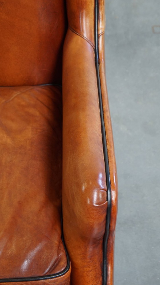 Image 1 of Schapenleren armchair met hoge rug en zwarte biezen 