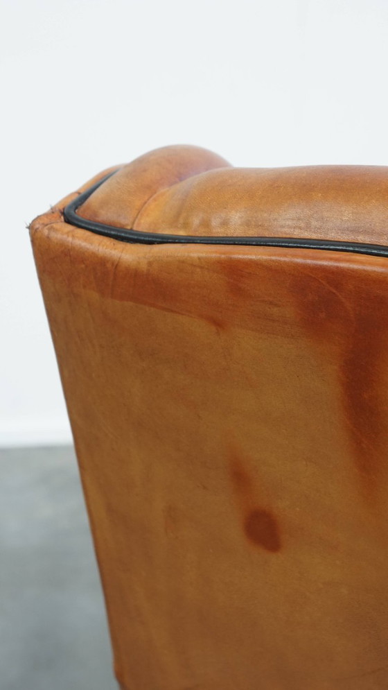 Image 1 of Schapenleren armchair met hoge rug en zwarte biezen 