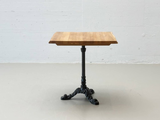 Image 1 of Bistro table made of acacia wood with a cast iron base in country style