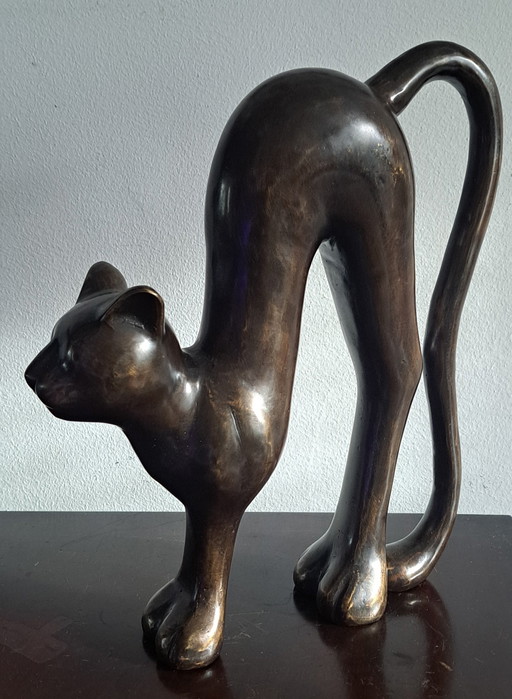 Scultura in bronzo di un gatto con la schiena alta
