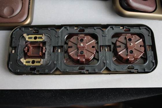 Image 1 of Large collection of vintage brown sockets and light switches with antique gold frames, 1960s/70s