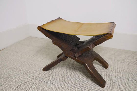 Image 1 of Brutalist Folding Stool Leather Sling Seat Hand Carved Wood X Frame 1950s Rustic Mid Century Ottoman