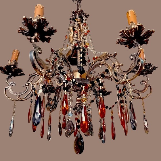 Image 1 of Una gran lámpara de araña de latón fundido con pátina.