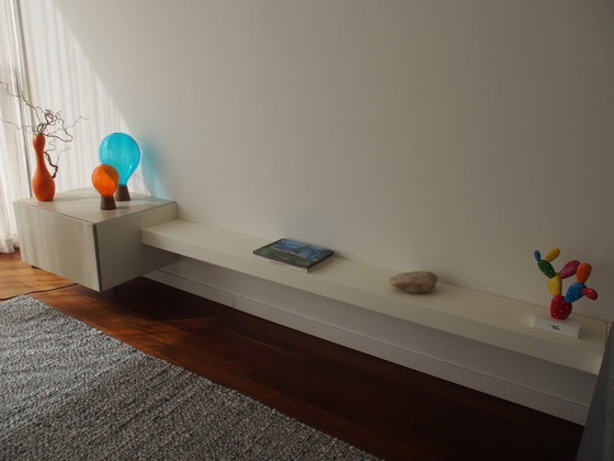 Image 1 of Armadio a ribalta di design con due mensole a muro adiacenti .