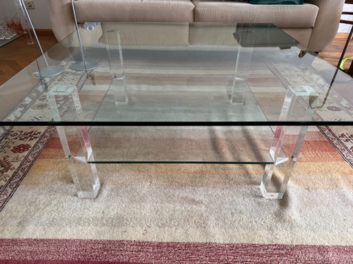 Sleek glass coffee table with plexiglass legs