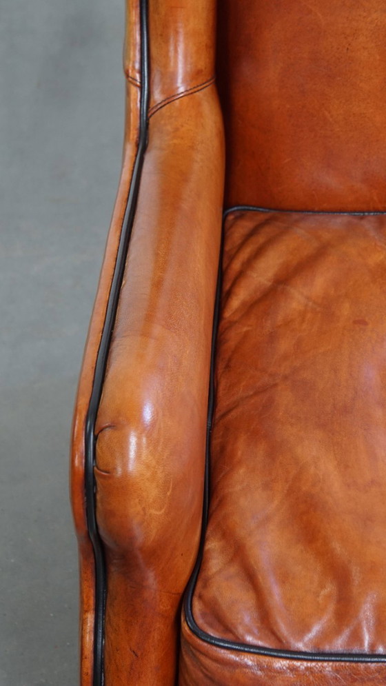 Image 1 of Schapenleren armchair met hoge rug en zwarte biezen 
