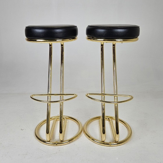 Image 1 of two bar stools, distinguished by their clean lines, high-quality craftsmanship, and timeless elegance.
