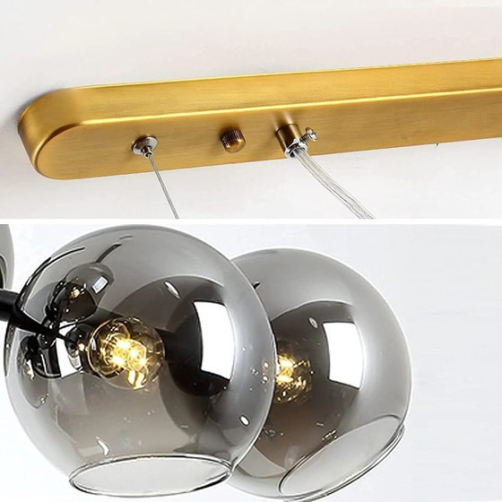 Image 1 of Dining room chandelier Illuminate your dining room with this modern chandelier composed of seven smoked glass globes. Its refine