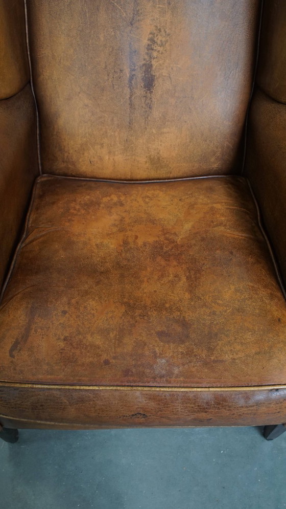 Image 1 of Karaktervolle vintage schapenleren oorfauteuil met een mooi patina