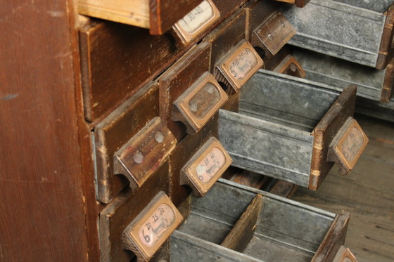Image 1 of Antique industrial apothecary cabinet • Vintage wood and metal drawer cabinet with many compartments