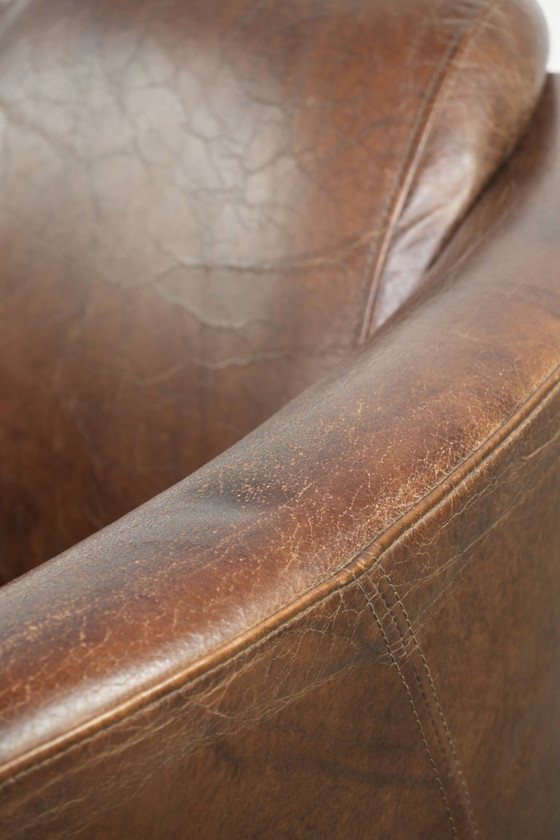 Image 1 of Karaktervolle en stoere donker cognac bruine rundleren Aviator design fauteuil/ armchair met een interessante vorm