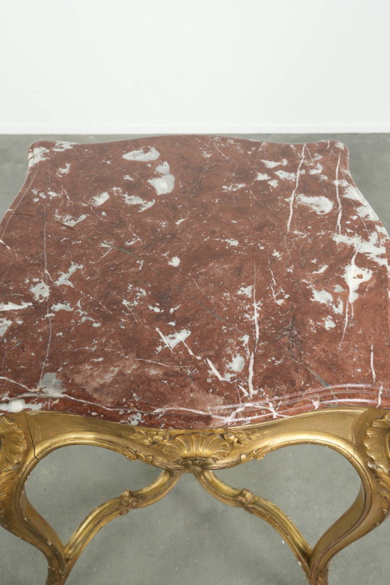 Image 1 of Antique French side table/center table from the 19th century with a gold-colored wooden frame and an original marble tabletop.