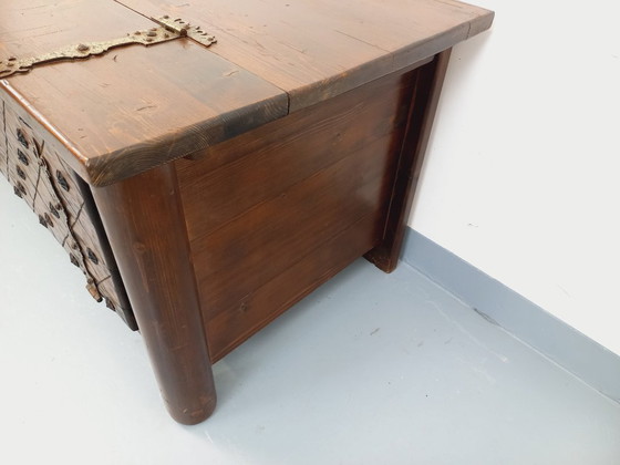 Image 1 of Een laag, brutalistisch dressoir van Georges Robert, gemaakt van donker grenenhout, uit de jaren 50/60.