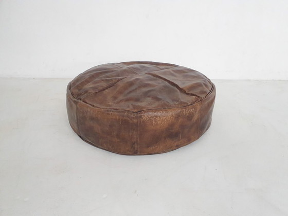 Image 1 of Dark brown leather ottoman. In good vintage condition
