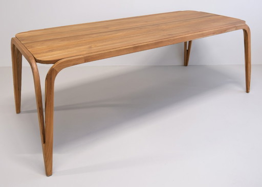 Handmade dining table made of solid teak with a natural finish