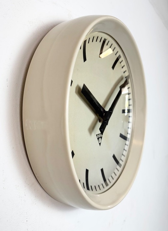 Image 1 of Industriële beige bakelieten fabriekswandklok van Pragotron, jaren 60